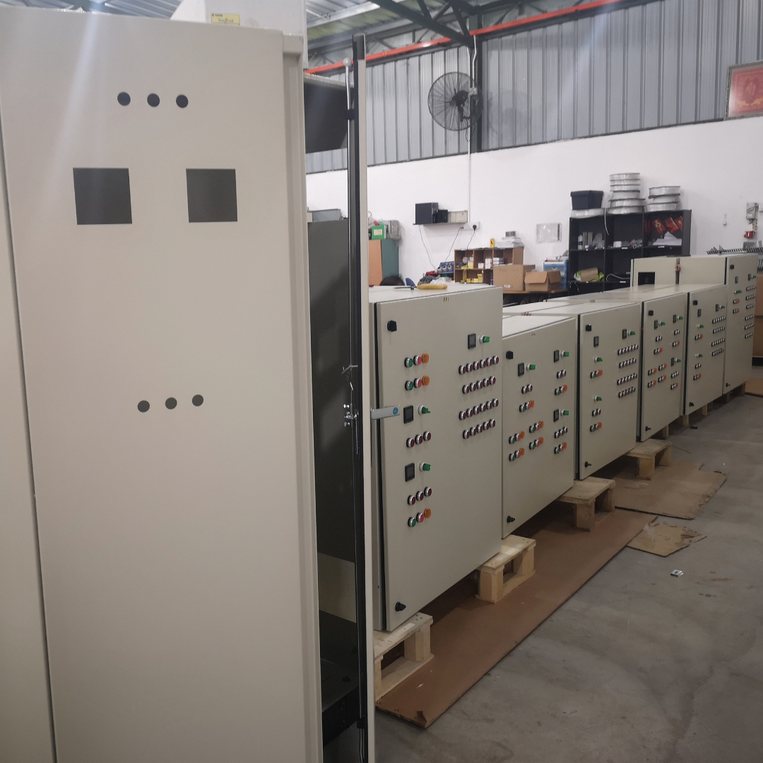 Cooling water control panel enclosures with push buttons and indicator lights in a workshop