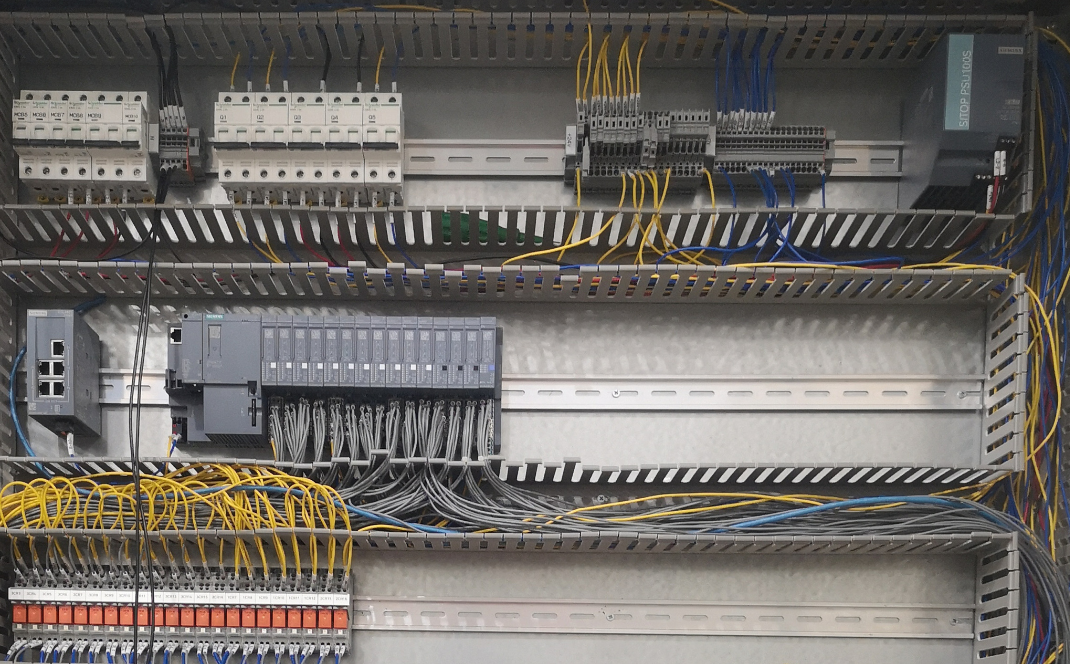 Internal wiring, terminal blocks, relays and controller modules inside a cooling water control panel