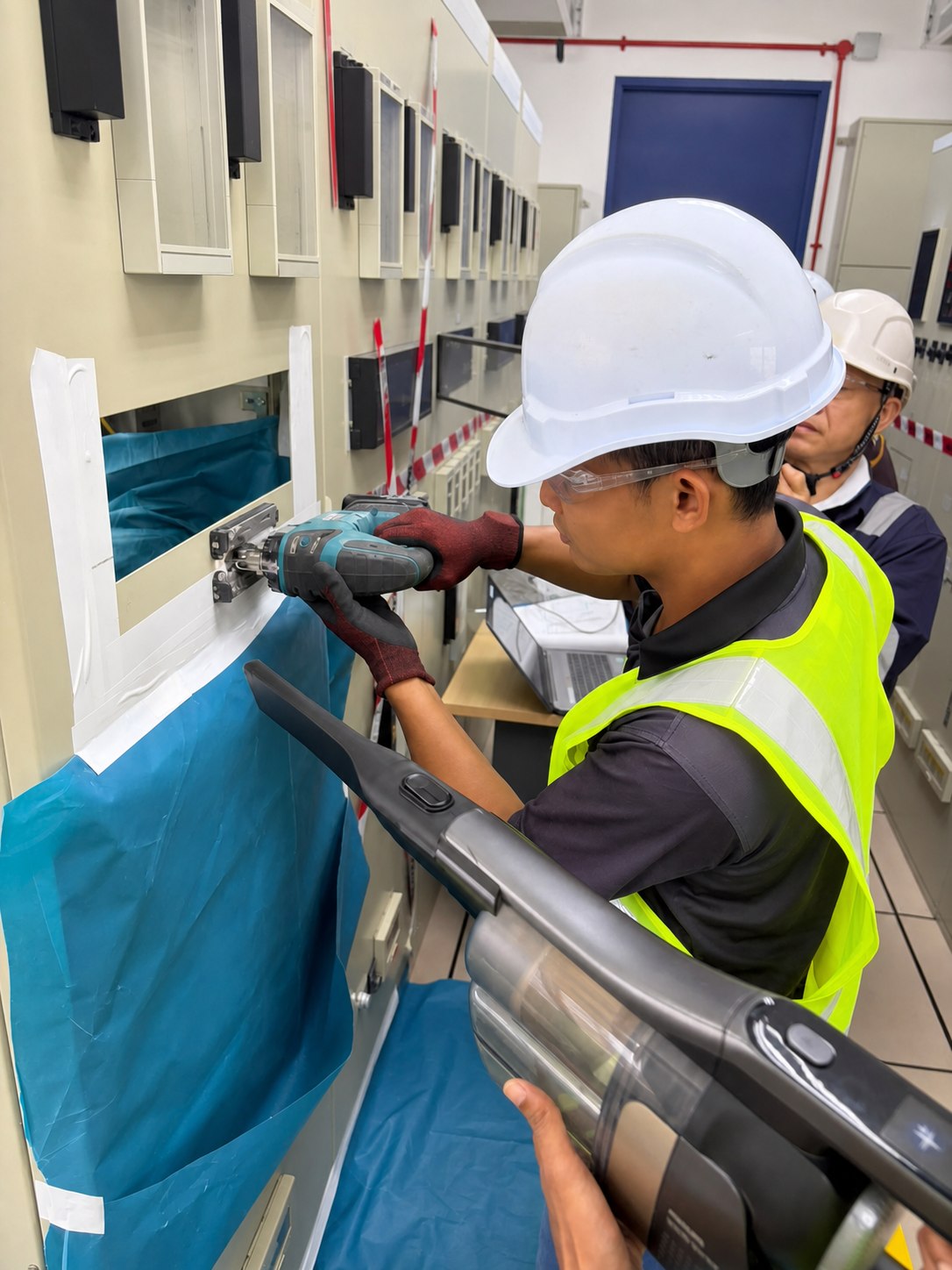 Technician performing control panel modification during relay replacement