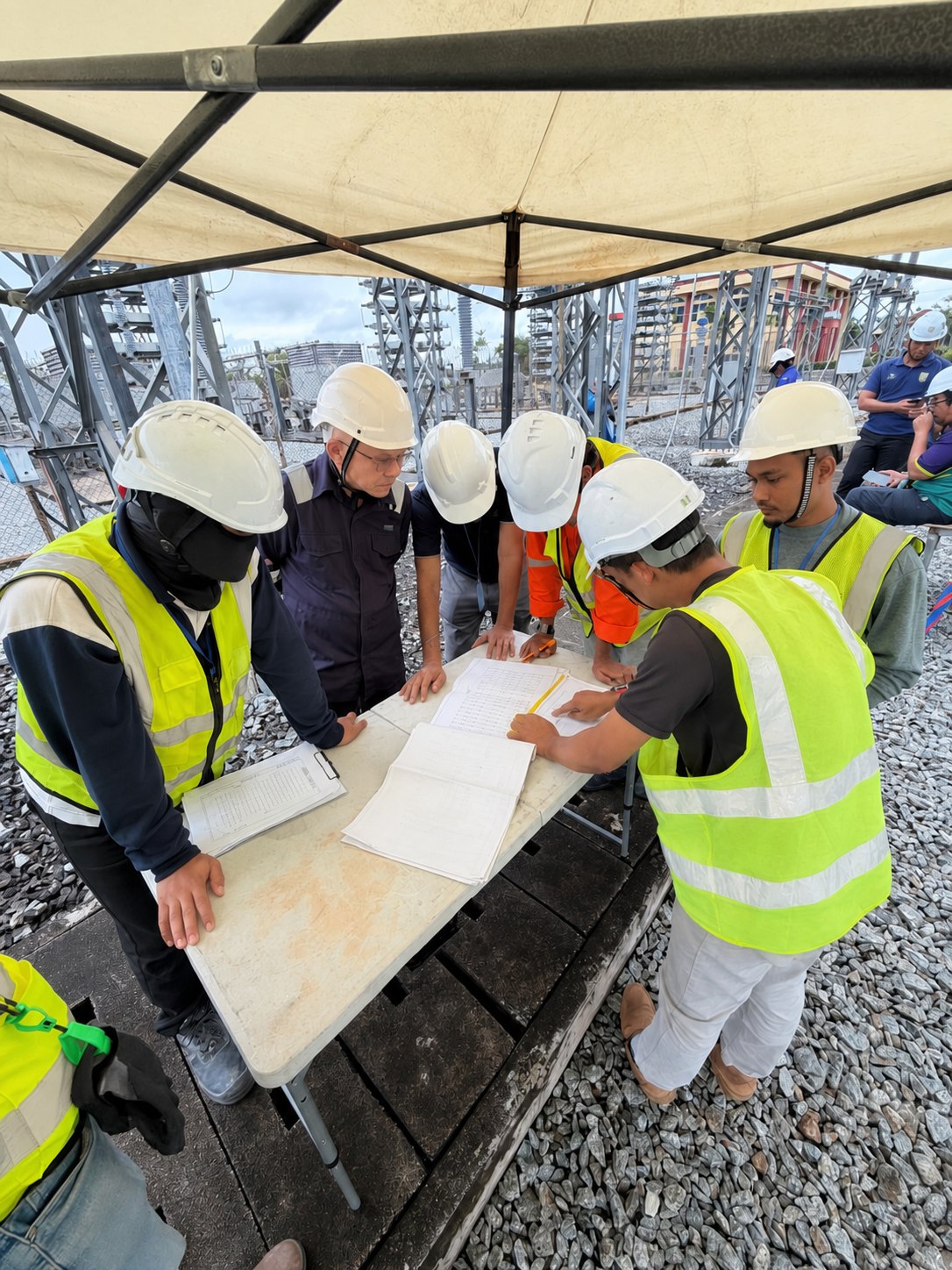 Engineering team reviewing controlled switching relay replacement work